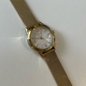 Gold Timex watch with mother-of-pearl watch face